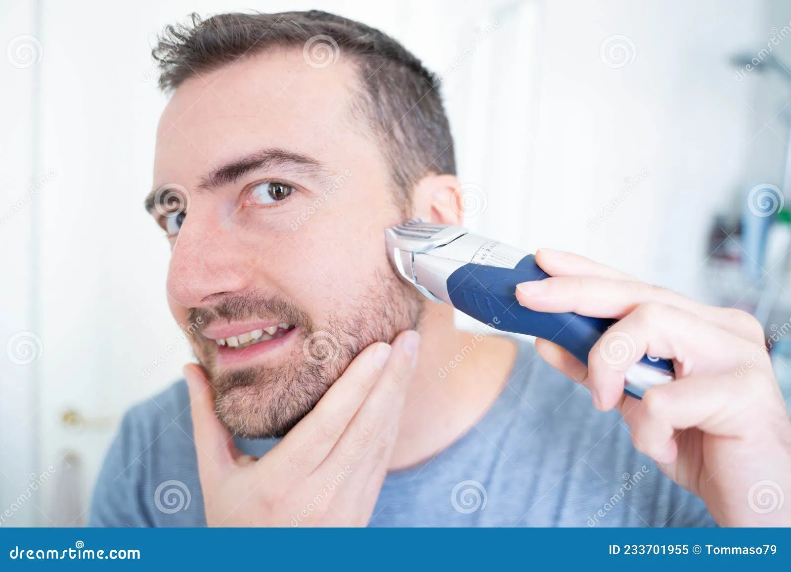 man using beard trimmer