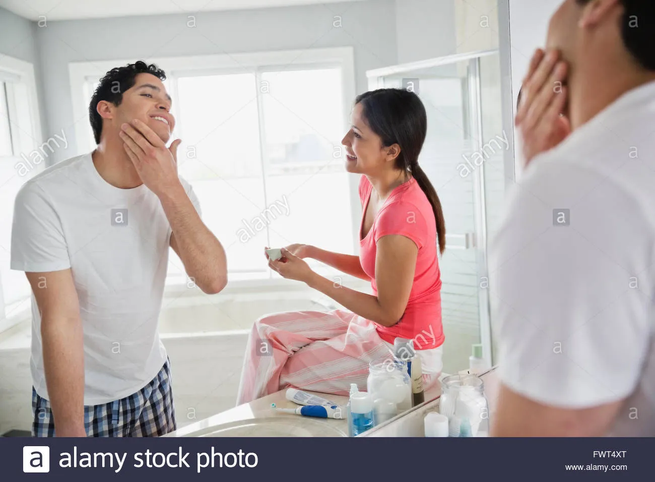 man applying aftershave
