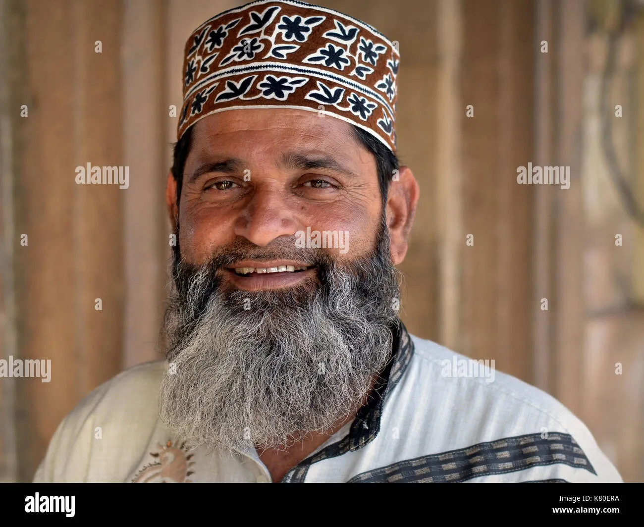 Short trimmed white beard Indian man